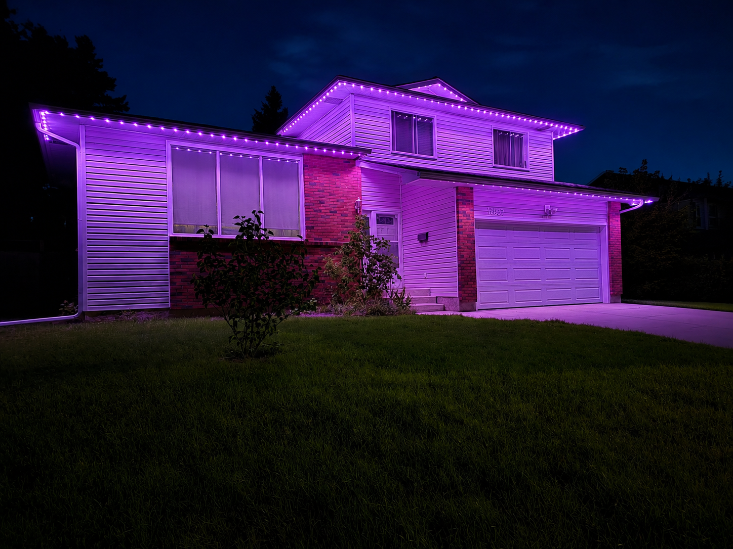 Permanent LED purple lighting on a home exterior at night